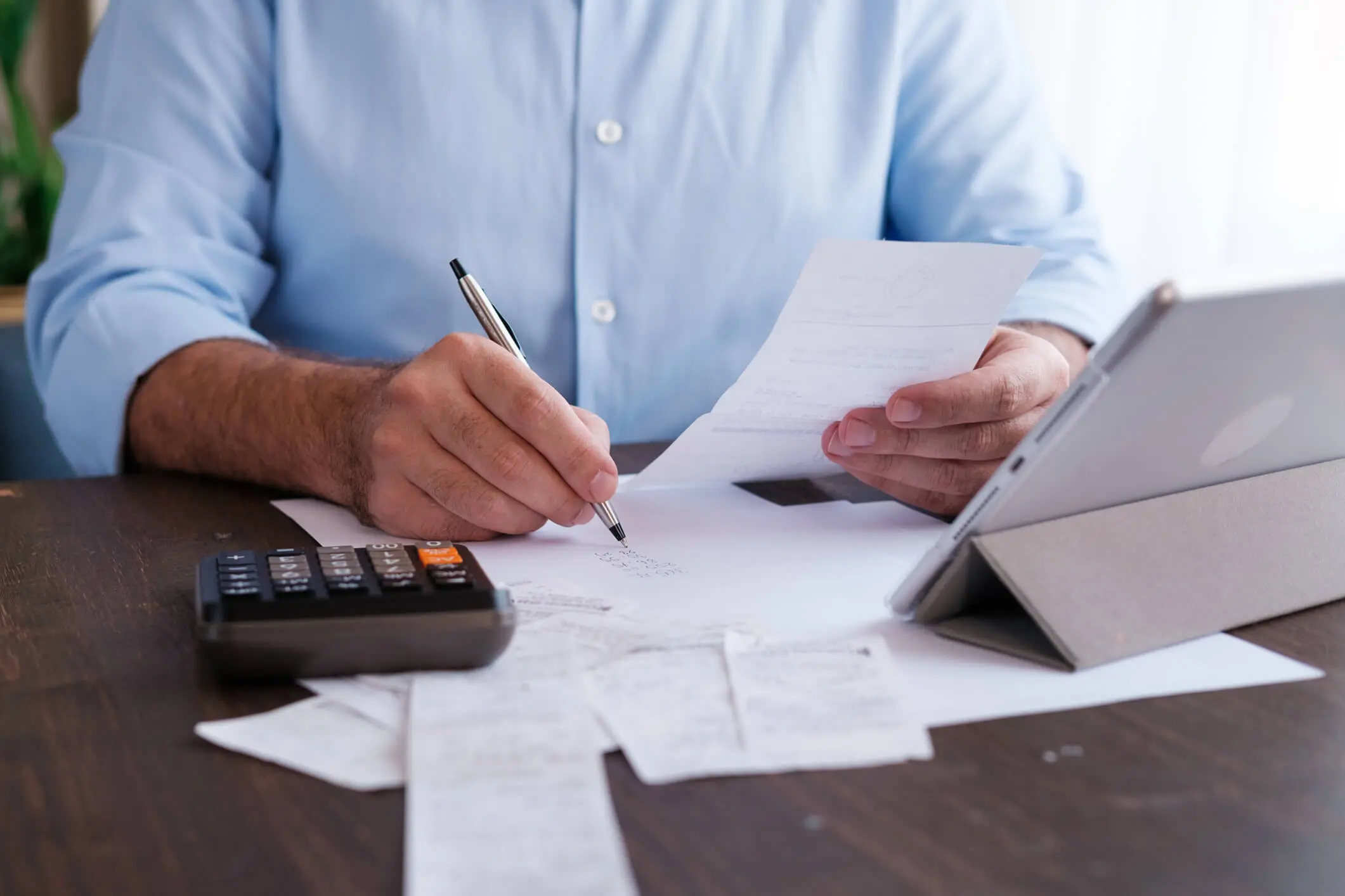 Individual working on budget with technology