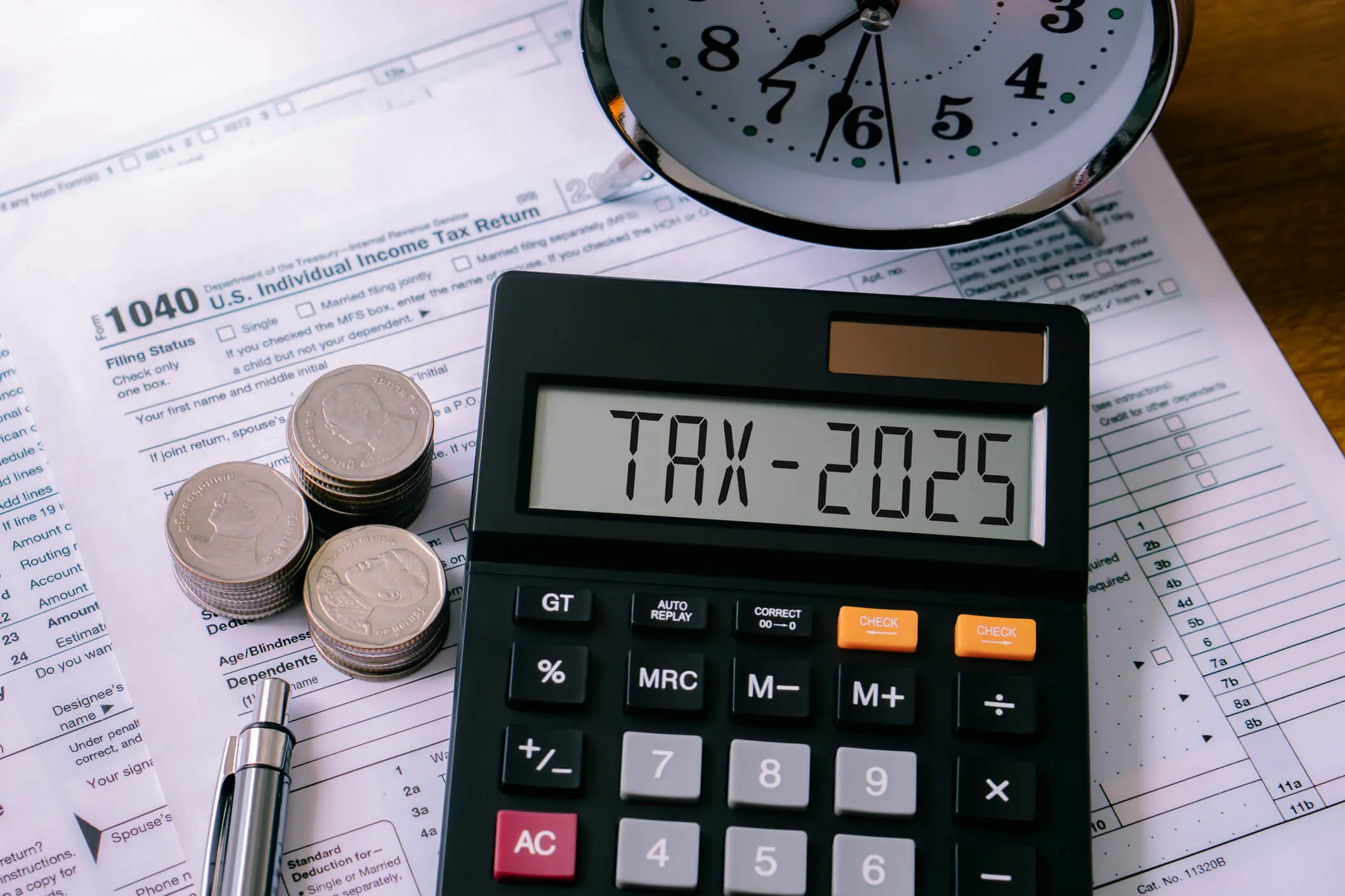 Tax preparation with calculator and paperwork.